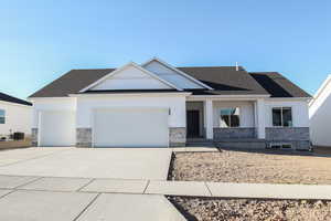 Craftsman-style home with a garage and central AC