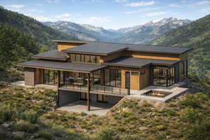 Rear view of property with a fire pit, a patio area, and a mountain view