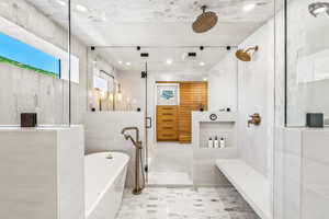 Bathroom with plus walk in shower, tile patterned flooring, and tile walls