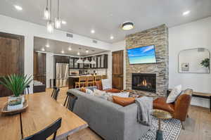 Living room with a fireplace and light wood-type flooring