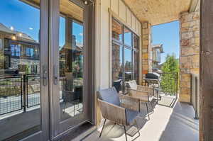 Balcony with a grill and covered porch