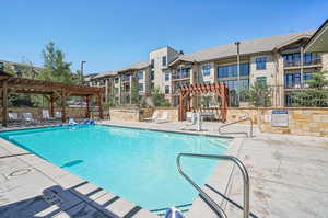 View of swimming pool featuring a pergola