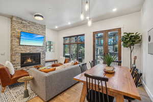 Living room featuring a stone fireplace and light hardwood / wood-style floors