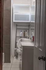 Bathroom featuring tile patterned floors, toilet, and vanity