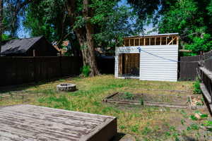 View of yard with a fire pit and an outdoor structure