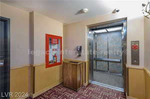 Bathroom featuring elevator and a textured ceiling