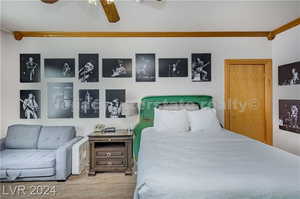 Bedroom featuring ceiling fan and ornamental molding