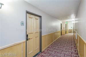 Corridor featuring a textured ceiling