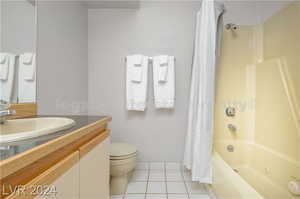 Full bathroom featuring vanity, tile patterned floors, toilet, and shower / bath combination with curtain