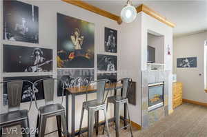 Dining space with light carpet and a fireplace