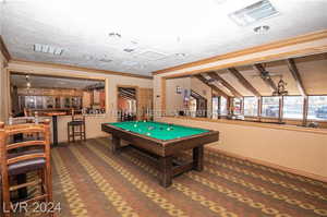 Playroom with vaulted ceiling with beams, ceiling fan, billiards, carpet, and ornamental molding