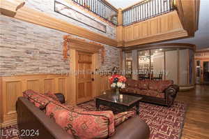 Living room featuring hardwood / wood-style floors and a towering ceiling