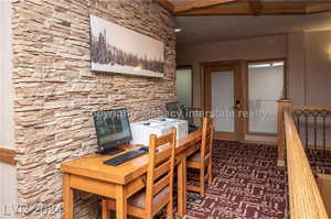 Dining space featuring beamed ceiling and carpet flooring