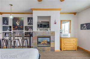 Bedroom with a fireplace and crown molding