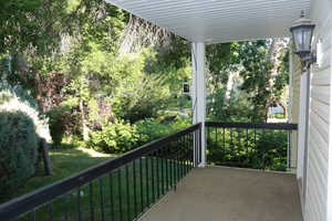 Deck looking to Master bedroom entrance and outdoor lawn and trees