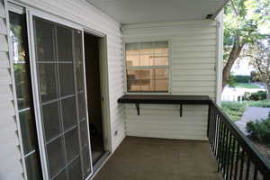 Deck view of living room entrance and kitchen window