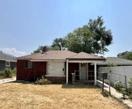 Rear view of house with a lawn