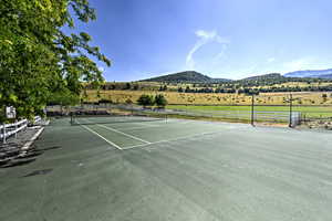 View of sport court with a mountain view and a rural view