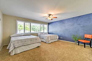 Carpeted bedroom with ceiling fan