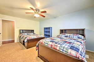 Carpeted bedroom with ceiling fan