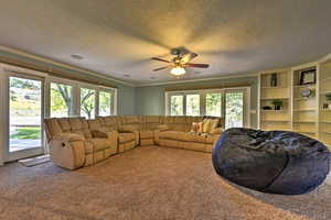 Living room with carpet floors and a wealth of natural light