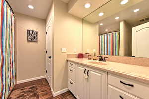 Bathroom with vanity and hardwood / wood-style flooring