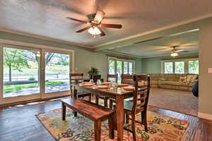 Dining area featuring hardwood / wood-style floors, a textured ceiling, ceiling fan, and ornamental molding