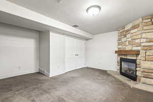 Basement with carpet floors and a fireplace