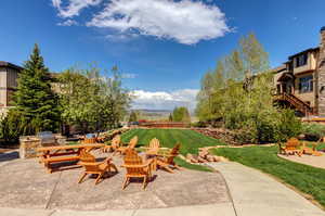 View of patio with an outdoor fire pit