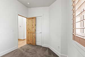 Unfurnished bedroom with carpet floors