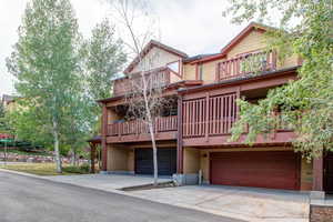 Exterior space with a garage and a balcony