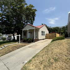 Bungalow-style home with a porch and a front lawn