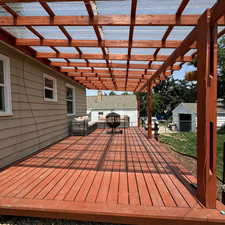 Deck featuring outdoor lounge area, a shed, and a pergola