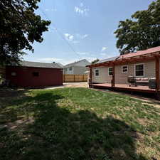 View of yard featuring cooling unit and a deck