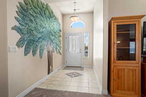 Foyer entrance featuring light tile patterned flooring