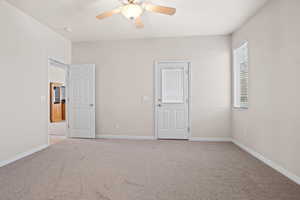 Unfurnished bedroom with light carpet and ceiling fan