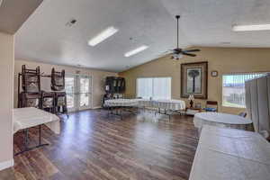 Living room featuring dark hardwood / wood-style floors, french doors, and lofted ceiling