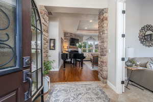 Entryway featuring wood-type flooring and a tray ceiling