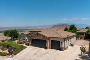 View of front facade featuring a garage, central AC, and a mountain view