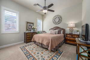 Carpeted bedroom featuring ceiling fan