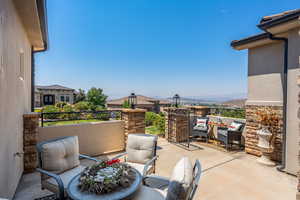 View of patio with a balcony and outdoor lounge area