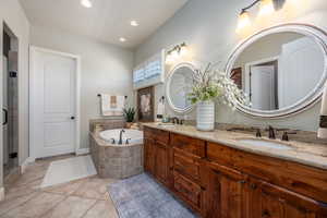 Bathroom with independent shower and bath, tile patterned flooring, and dual bowl vanity