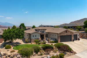 View of front of property with a mountain view and a garage