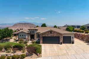 View of front of property with a mountain view and a garage