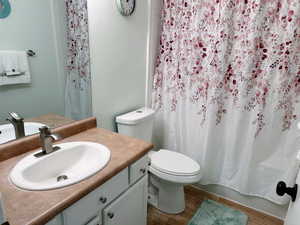 Bathroom featuring vanity, vinyl flooring, and toilet