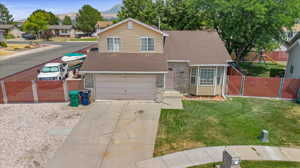 View of front of property featuring a garage, a front lawn