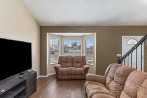 Living room with dark hardwood / wood-style flooring