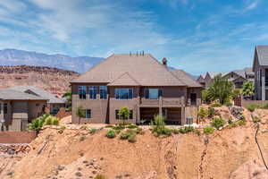 Back of property featuring a mountain view and central air condition unit