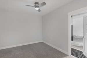 Carpeted empty room featuring ceiling fan