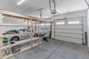 Garage featuring a workshop area and a garage door opener